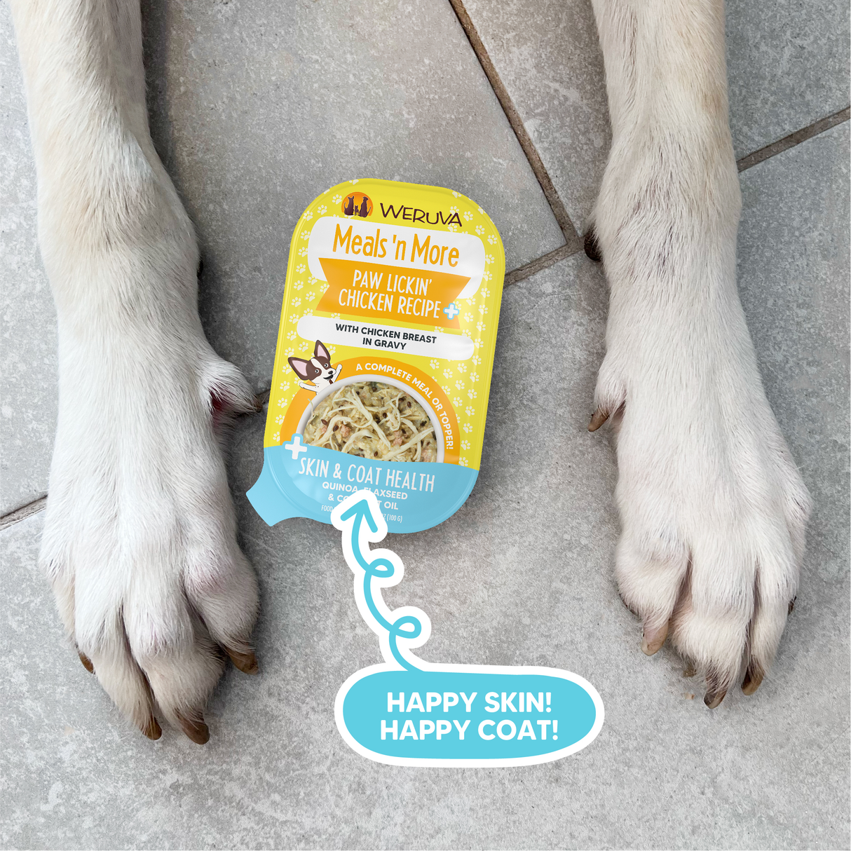A container of Weruva Paw Lickin' Chicken Recipe Plus dog food, made with real white meat chicken, sits between a dog's front paws on the tiled floor. A blue label points to it and reads: HAPPY SKIN! HAPPY COAT!.