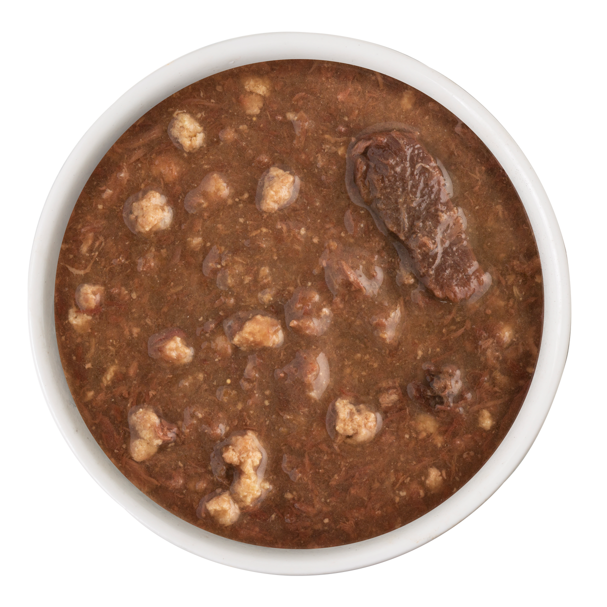 A white bowl containing Soulistic Tuna & Turkey Dinner in Gravy, with chunky meat pieces and small meatballs, viewed from above on a white background.