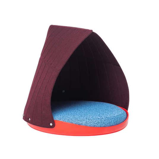 A modern pet bed with a maroon fabric canopy, a round blue cushion, and a red circular base, photographed on a plain white background.