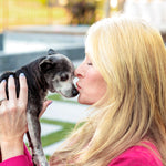 a woman kissing a dog a woman kissing a dog