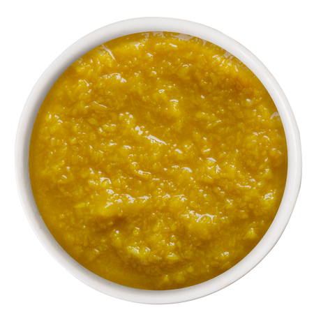 A white bowl filled with Weruva Puréed Pumpkin Supplement for digestive support.