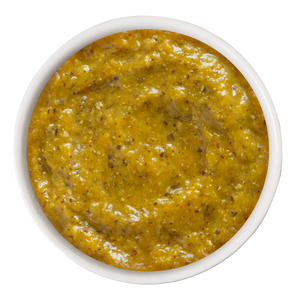 A small bowl of Weruva Pumpkin with Coconut Oil & Flaxseeds Supplement, featuring orange pumpkin puree mixed with flaxseeds.
