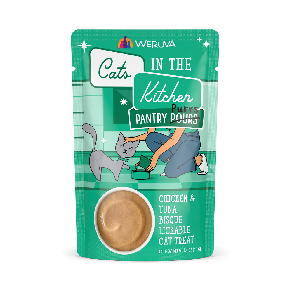 A teal Cats in the Kitchen Chicken & Tuna Bisque pouch features an illustration of a person feeding a gray cat and a circular window displaying the lickable treats inside.