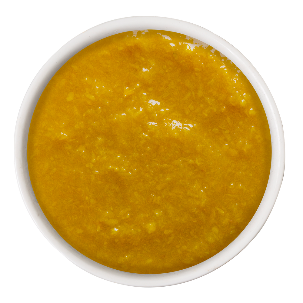 A small bowl filled with Weruva Pumpkin with Ginger & Turmeric Supplement, an orange pumpkin puree for digestive support.