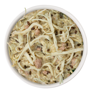Weruva’s Paw Lickin' Chicken Recipe Plus features real white meat chicken, quinoa, seeds, and visible grains in a creamy beige sauce for a wholesome meal.