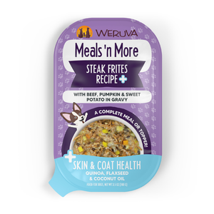 A purple Weruva pouch labeled “Steak Frites Recipe Plus” features grass-fed beef, pumpkin, and sweet potato in gravy for skin and coat health. The convenient package displays food imagery and a cartoon dog.