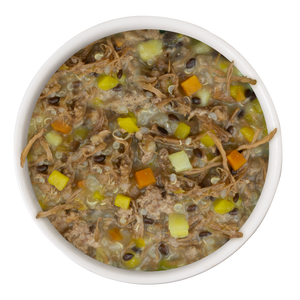 A white bowl filled with Weruva Steak Frites Recipe Plus—grass-fed beef dog food with diced veggies, grains, and broth—viewed from above against a white background; a convenient meal promoting healthy skin and a shiny coat.