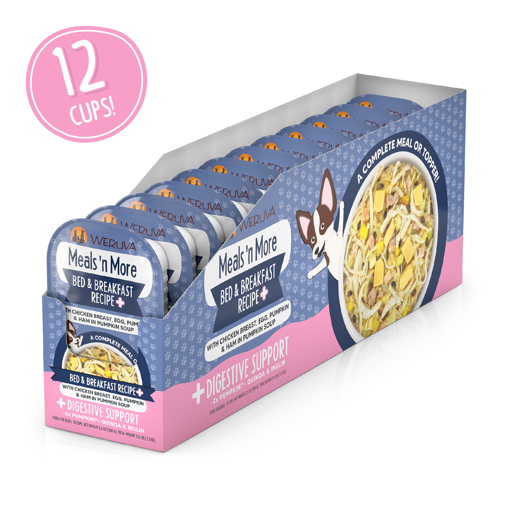 A 12-pack of Weruva Bed and Breakfast Recipe Plus dog meal cups is on display, featuring real chicken, egg, and pumpkin with a cartoon dog and text promoting easy digestion and digestive support.