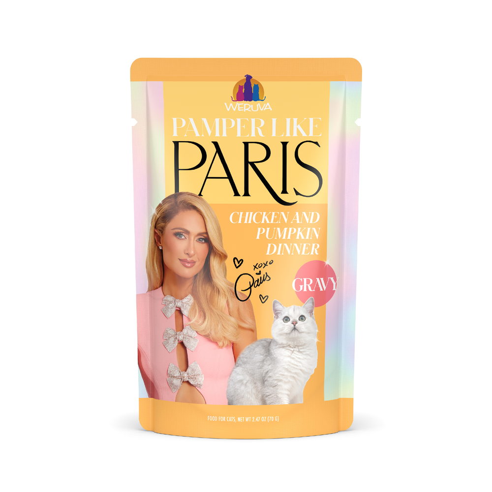 A pouch of Weruva Chicken and Pumpkin Dinner in Gravy cat food, featuring a glamorous blonde woman and a gray cat on a pastel background.