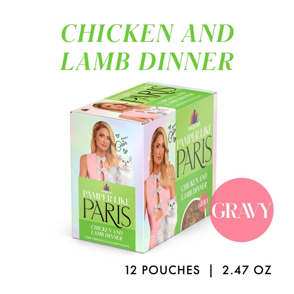 A box of “Weruva Chicken and Lamb Dinner in Gravy” cat food is shown. The package displays a blonde woman with a white cat, highlights 12 pouches (2.47 oz each), and features “GRAVY” in a pink circle, emphasizing the silky gravy inside.