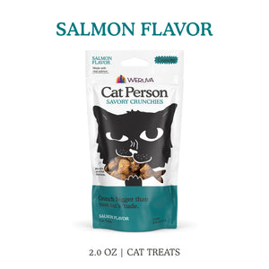 A 2.0 oz bag of Cat Person Salmon Savory Crunchies low calorie cat treats. The white and teal packaging features a black cat illustration with treats in its mouth.