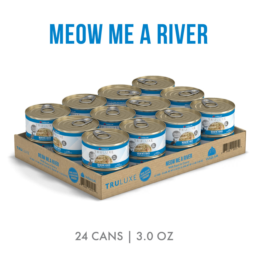 A cardboard tray holds 24 cans of TruLuxe Meow Me a River cat food, each blue and white. Text above says “MEOW ME A RIVER,” below “24 CANS | 3.0 OZ.”, showcasing refined nutrition for your cat.