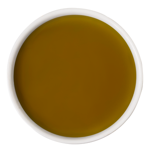A white bowl of golden-yellow olive oil on a white background—a nourishing touch often added to dog wellness routines alongside Awesome Functions’ Awesome Everything Super Beef Bone Broth.