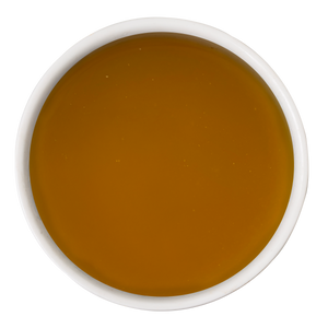 A white bowl filled with Awesome Everything Super Chicken Bone Broth by Awesome Functions, viewed from above on a plain white background—a nourishing meal mixer that supports dog wellness.