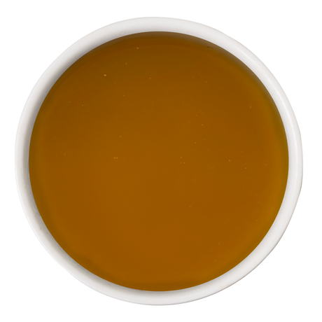 A white bowl filled with Awesome Everything Super Chicken Bone Broth by Awesome Functions, viewed from above on a plain white background—a nourishing meal mixer that supports dog wellness.