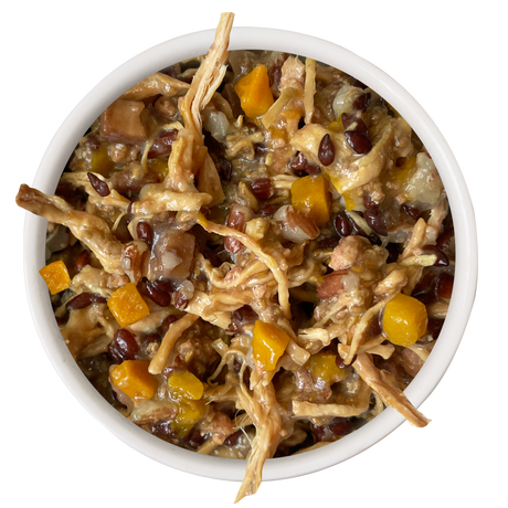 A white bowl of Awesome Functions Awesome Everything Chicken Breast & Red Rice Recipe with Pumpkin—featuring shredded chicken, red beans, bell peppers, onions, and creamy sauce—is perfect for boosting your pup’s nutrition.