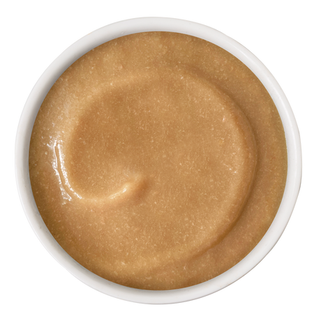 A white bowl filled with smooth Chicken & Tuna Bisque from Cats in the Kitchen, resembling a lickable treat, viewed from above on a white background.