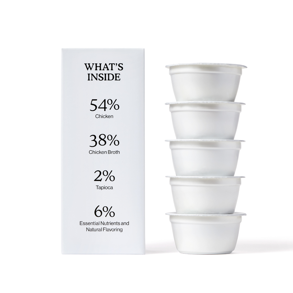 A box for Cat Person Chicken Shreds in Broth lists: 54% high-quality chicken, 38% chicken broth, 2% tapioca, and 6% essential nutrients. Four stacked containers highlight this protein-rich cat food’s balanced nutrition.