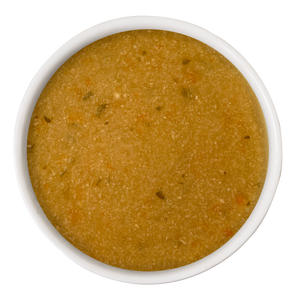 A white bowl filled with Dogs in the Kitchen Chicken & Sweet Potato Gravy Meal Topper, featuring light brown broth with bits of veggies and herbs, viewed from above on a white background—a perfect mealtime topper.