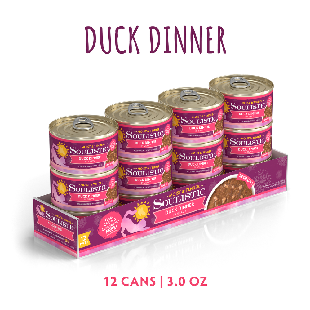 A 12-pack of Soulistic Duck Dinner in Gravy cat food, each 3.0 oz can, features deboned duck for quality protein. The pink packaging shows a cat and duck and is labeled Grain, Gluten & MSG Free.