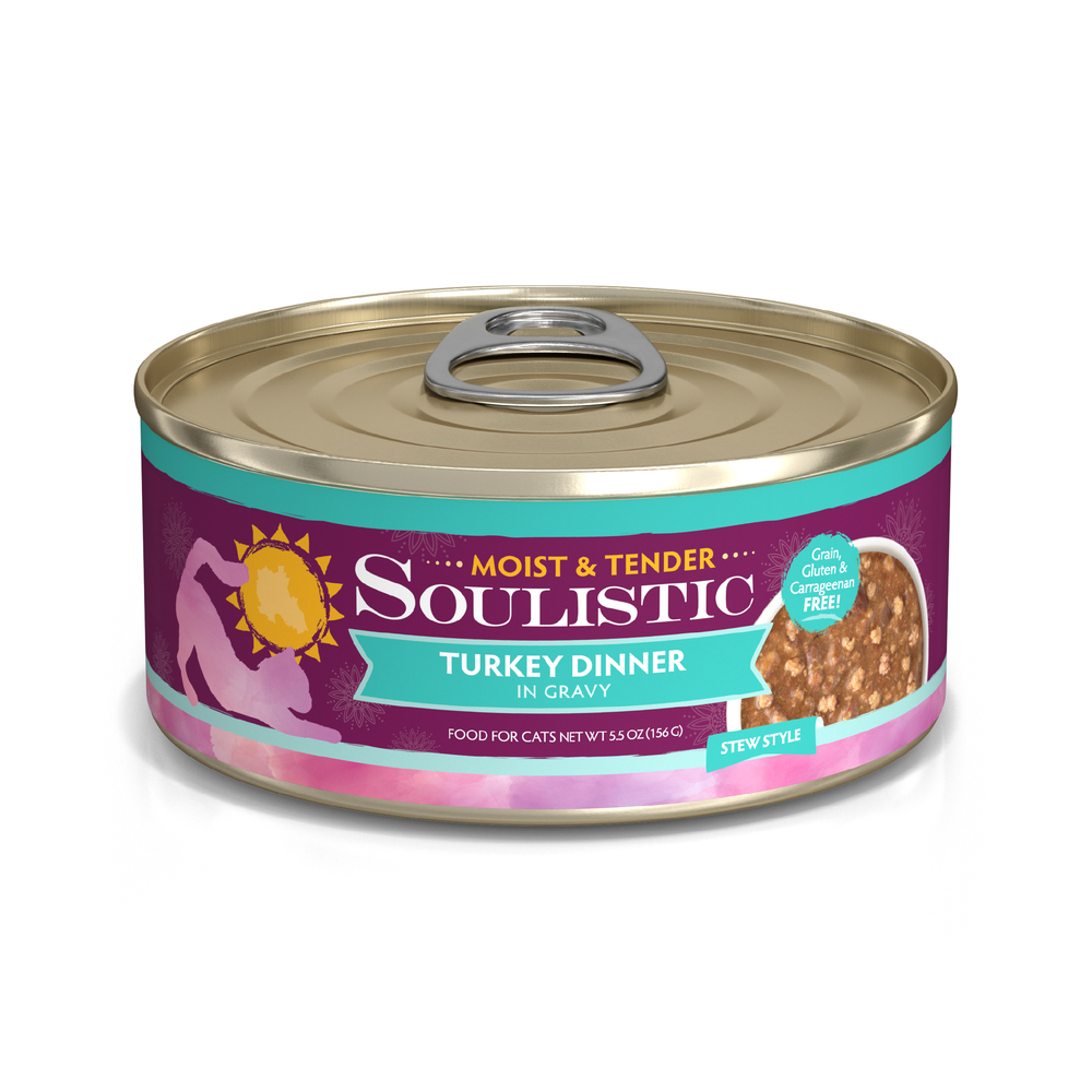 A can of Soulistic Turkey Dinner in Gravy cat food, with minced deboned turkey for quality protein, features a purple and teal label with a cat silhouette, sun graphic, and a photo of the stew-style meal.