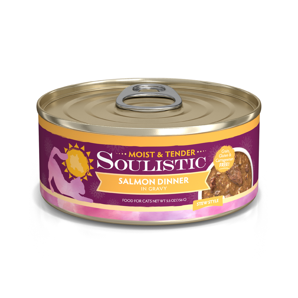 A can of Soulistic Salmon Dinner in Gravy cat food, stew style with wild-caught salmon for quality protein. The purple and gold label features a cat silhouette, sun, and highlights grain-free ingredients.