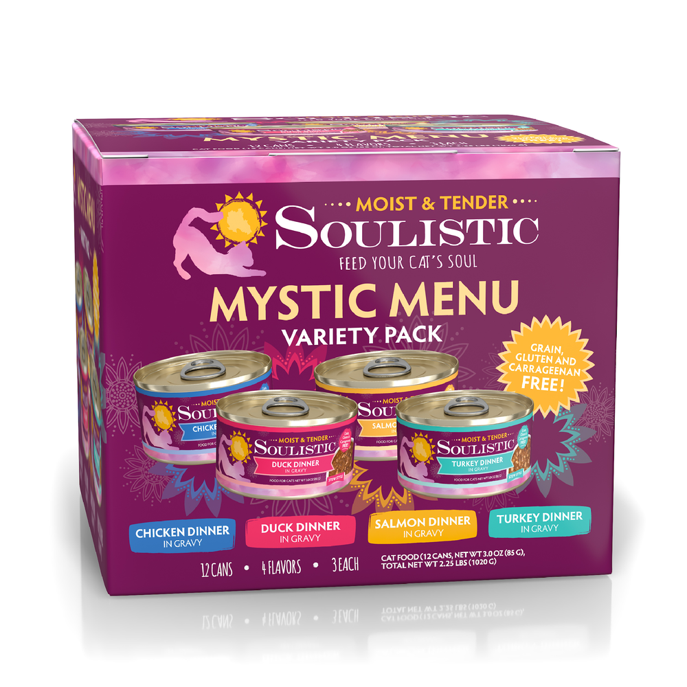 A purple box of Soulistic Mystic Menu cat food with four minced, deboned meat dinners—chicken, duck, salmon, and turkey—in gravy. Features high-quality protein and is grain, gluten & carrageenan free.