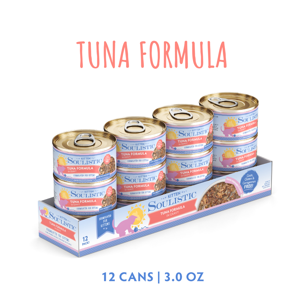 A 12-pack tray of Soulistic Tuna Formula in Gravy kitten food is shown, each 3-oz can with a colorful label and gold lid. Made with wild-caught tuna for early development. Text on pack: Tuna Formula in Gravy, 12 Cans | 3.0 oz.