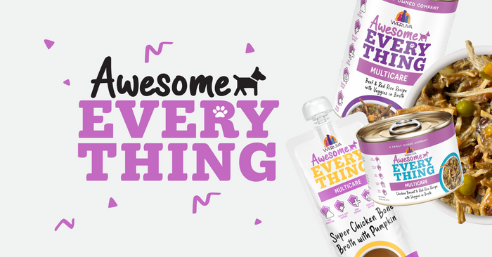 “Awesome Everything” pet food packaging in white and purple, featuring cans, a pouch, brown and purple text, and playful confetti accents. Some cans are open, showing food with vegetables.