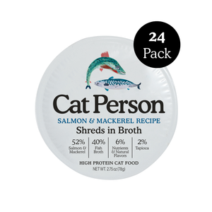 A round container of Cat Person Salmon & Mackerel Shreds in Broth features images of salmon and mackerel, key ingredient percentages, and a black circle stating 24 Pack—highlighting this balanced, protein-rich cat food.