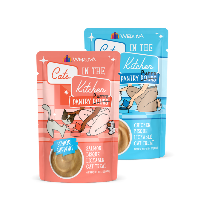 Two pouches of Weruva Cats in the Kitchen Pantry Pouches cat treats, one in red for Salmon Bisque (senior support) with a cartoon cat and owner, and one in blue for Chicken Bisque, both with visible cat treat inside.