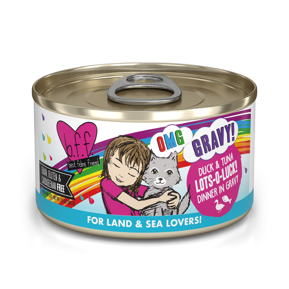 A can of BFF Best Feline Friend Duck & Tuna Lots-O-Luck! cat food features colorful text, a cartoon girl hugging a gray cat, and labels like OMG GRAVY!—perfect for gravy-loving cats and fans of land and sea flavors.