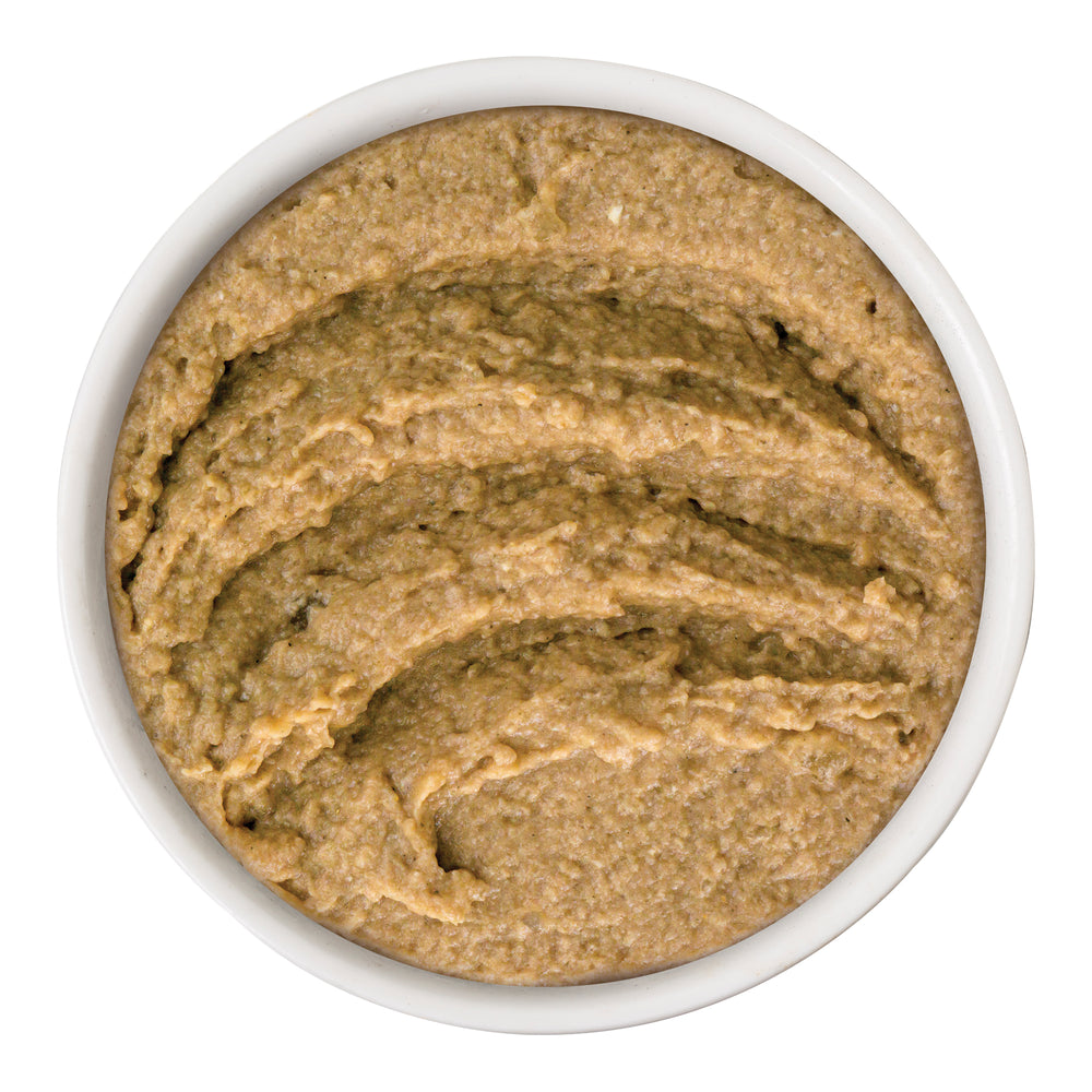 A white bowl from above displays The Newly Feds, a smooth, light brown grain-free spread or dip by Weruva, on a white background.
